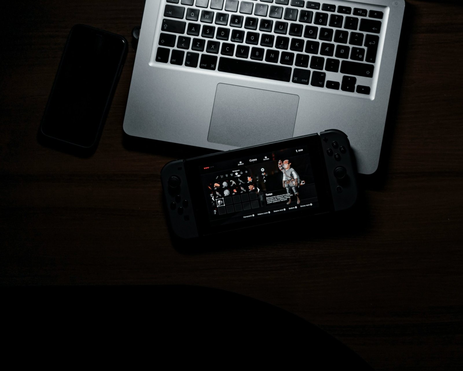 black iphone 7 beside macbook pro